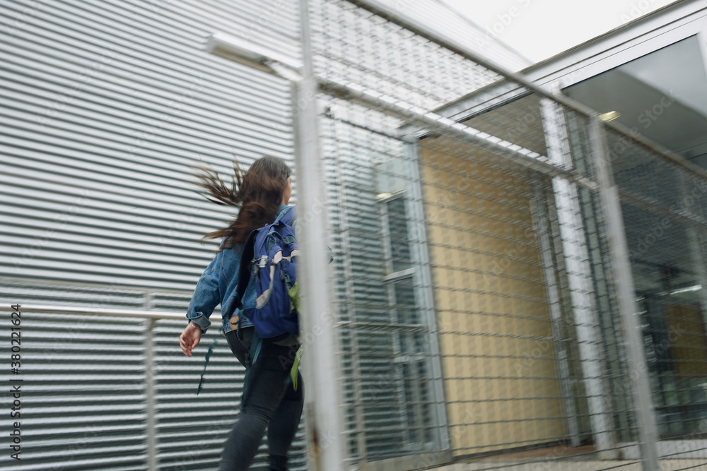 Girl running into the school entrance Girl running into the school entrance