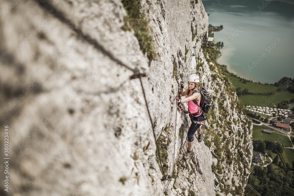 young woman climbing young woman climbing