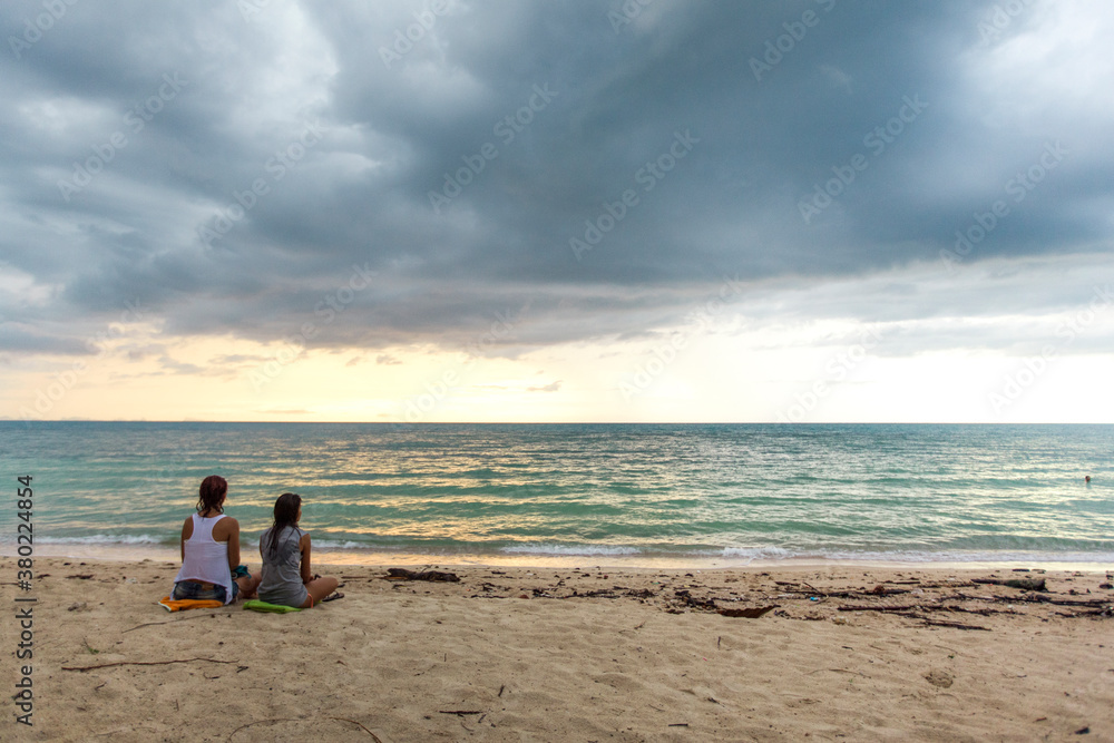 Girlfriends Sitting on the Beach Girlfriends Sitting on the Beach