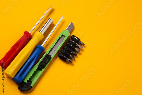 screwdrivers and construction tools on yellow background equipment for repair industry