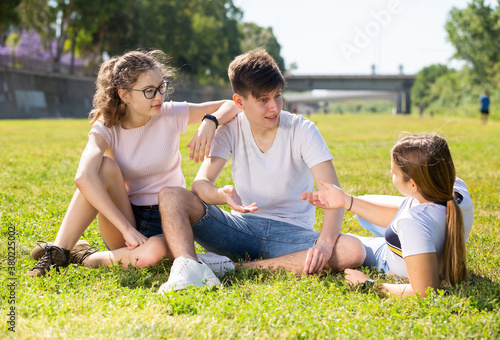 Portrait of positive teenagers on the summer green lawn © JackF