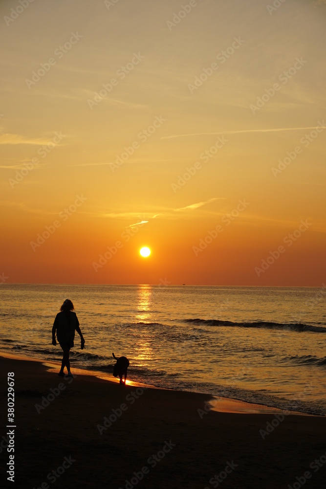 walker in the beach sunset