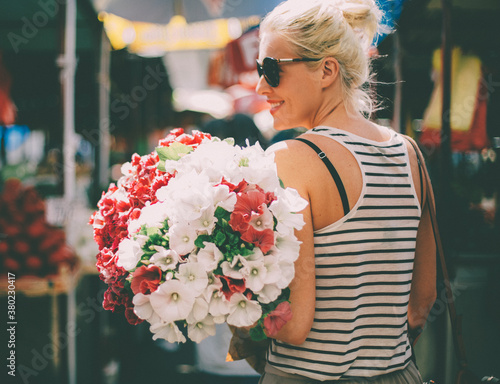 Smiling Woman Carrying Flowers