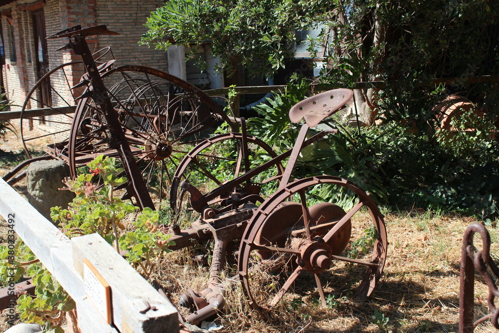 Santa Severa(RM)Italy-July 18,2020:Antique agricultural equipment,inside The medieval village,stone house architecture,Perfect destination for visit the old Medieval district. Santa Severa(RM)Italy-July 18,2020:Antique agricultural equipment,inside The medieval village,stone house architecture,Perfect destination for visit the old Medieval district.