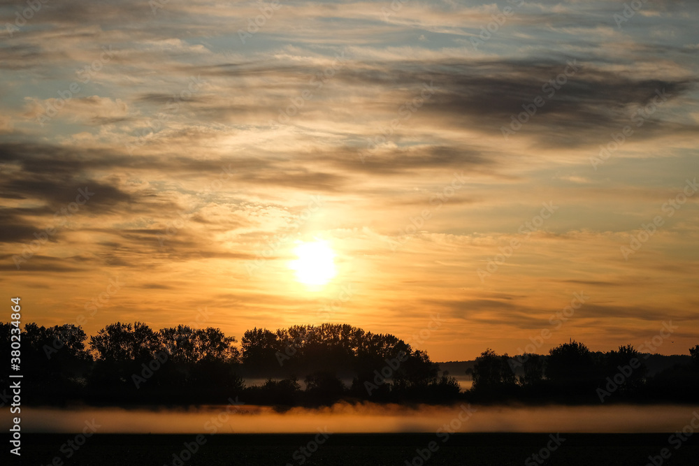 Fototapeta premium sunset or sunrise over the field