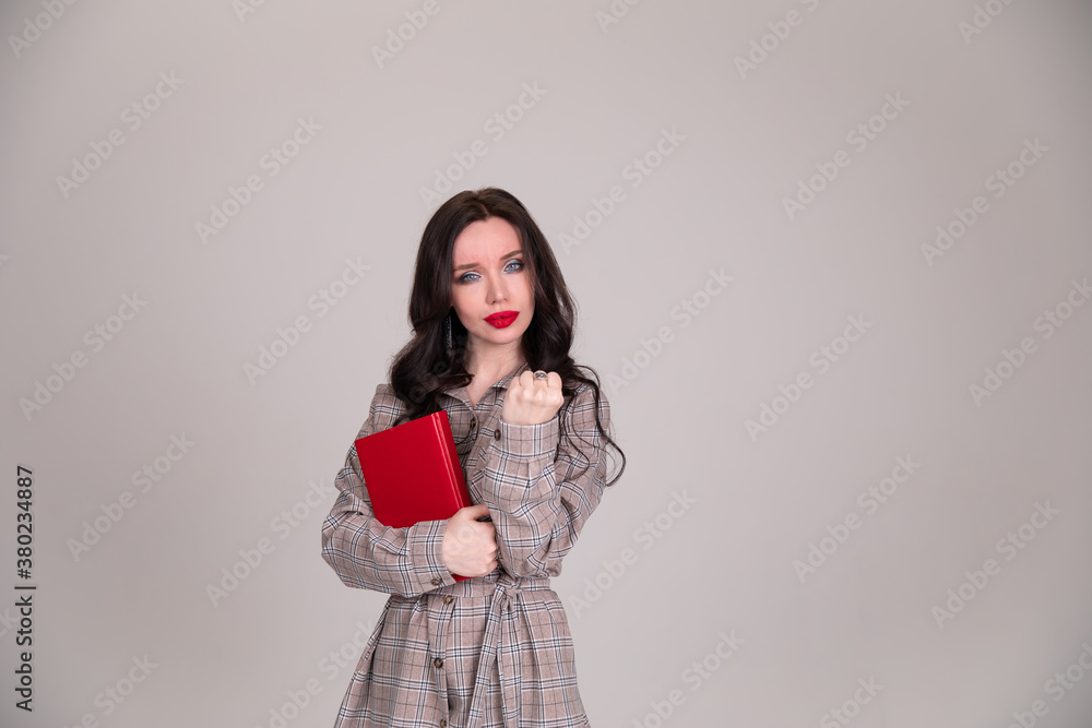 Fototapeta premium girl on white background shows his fist. Female force. Feminism