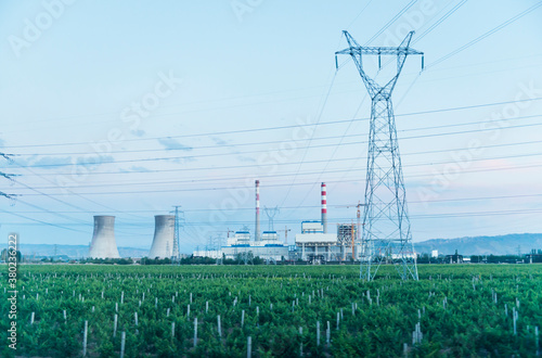 Chimney of power station on field under blue sky photo