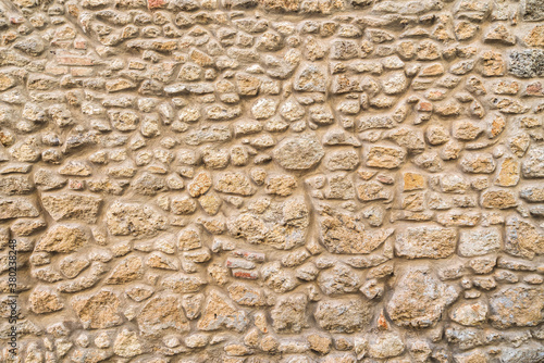 Exposed stone wall background, pattern, texture in Tuscany.