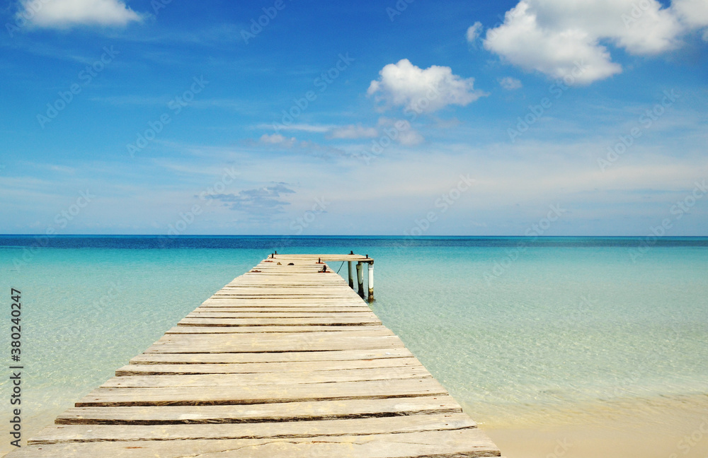 Wooden pier on a perfect tropical Caribbean white sand beach Wooden pier on a perfect tropical Caribbean white sand beach