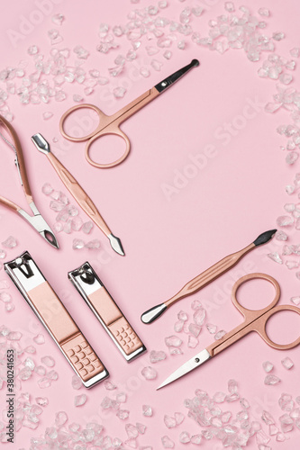 Tools of a manicure set on a pink background. Copy space for text. Top view