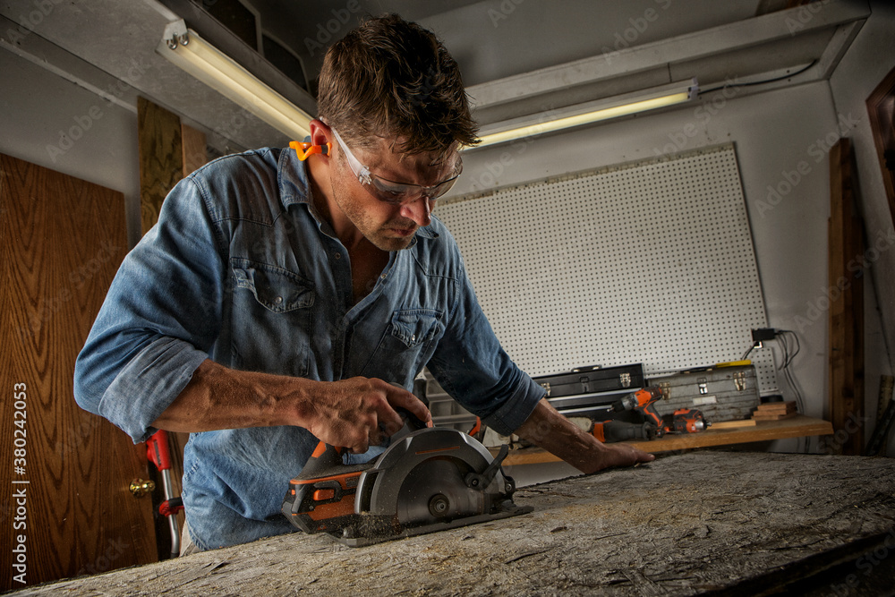 Man sawing a board Man sawing a board