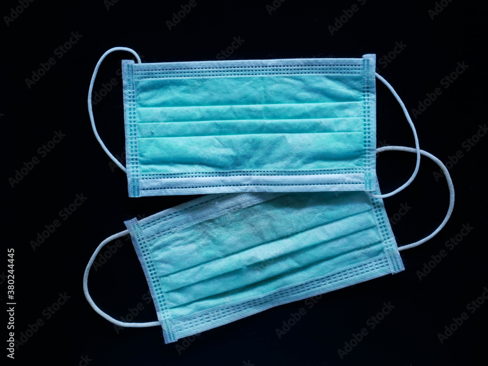 Used face mask Was left on the floor. concept corona virus and medical mask Used face mask Was left on the floor. concept corona virus and medical mask