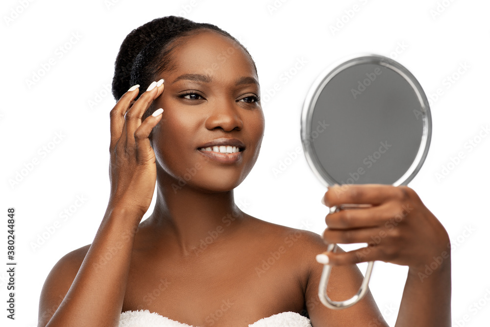 beauty and people concept - portrait of happy smiling young african american woman with bare shoulders looking to mirror over white background beauty and people concept - portrait of happy smiling young african american woman with bare shoulders looking to mirror over white background