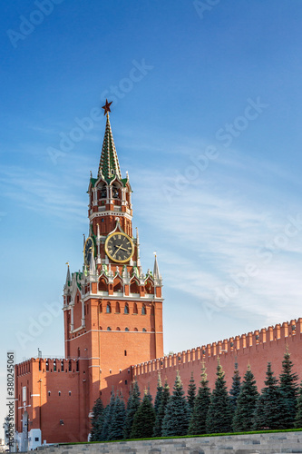 The Kremlin's Spasskaya Tower on Red Square against the backdrop of a bright blue sky on a sunny day. Vertical.