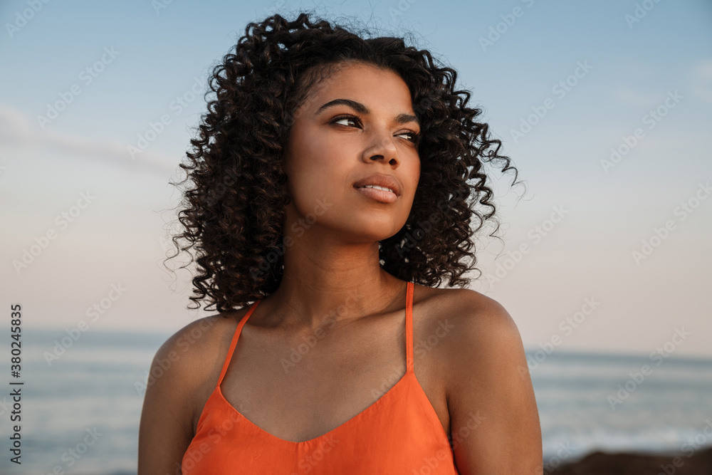 Young african woman walking at the beach Young african woman walking at the beach