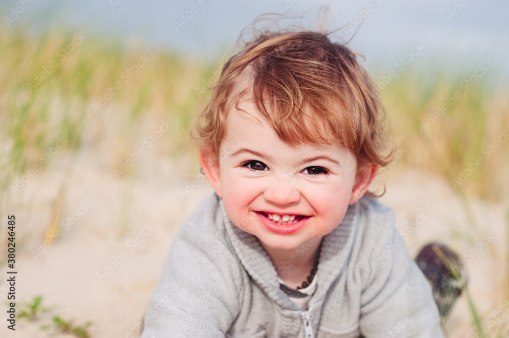 Portrait of a toddler at the beach in winter Portrait of a toddler at the beach in winter