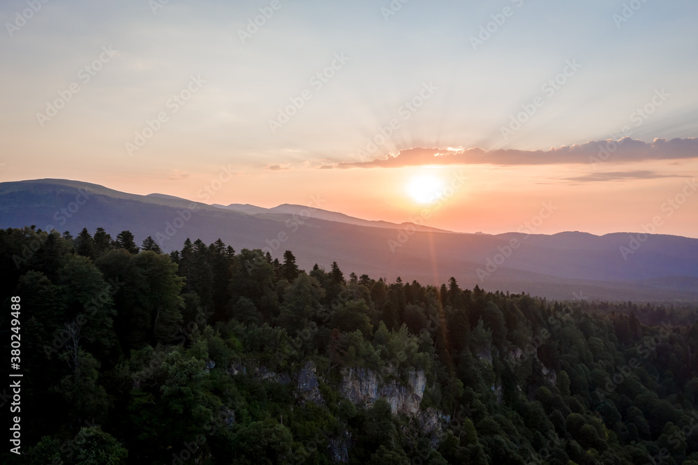 Obraz premium Sunset over the coniferous forest. Lagonaki plateau, Caucasus, Russia