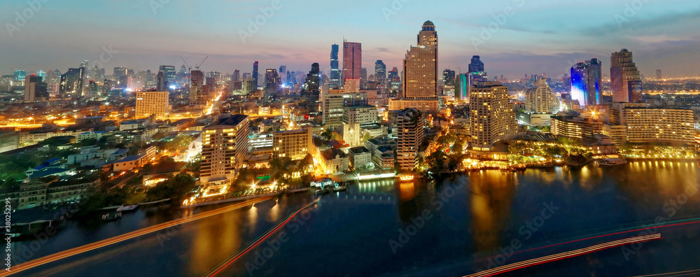 Urban skyline of Bangkok in morning twilight, with hotels & office towers by Chao Phraya River & MahaNakhon amid modern skyscrapers under dawning sky~Morning scenery of Bangkok City in bird's eye view