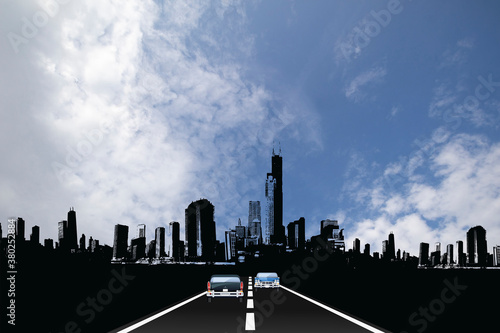 Traffic on roadway leading to generic silhouetted city skyline with blue cloudy sky 