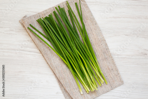 Raw Green Onions on a white wooden background, top view. Flat lay, overhead, from above.