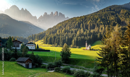 misty countryside scenery in mountains at sunrise. beautiful landscape of Dolomites with meadows rolling through forested hills in morning light. wonderful nature scene for summer background.