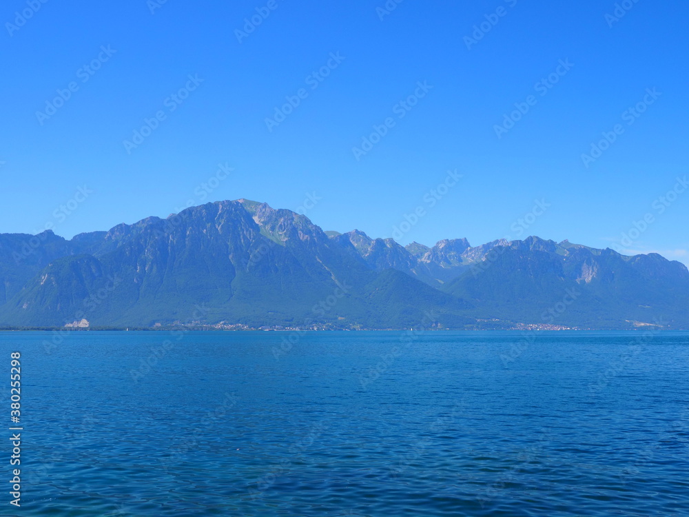 Obraz premium Marvelous landscapes of Lake Geneva in european Montreux city in canton Vaud in Switzerland, clear blue sky in 2017 warm sunny summer day on July.