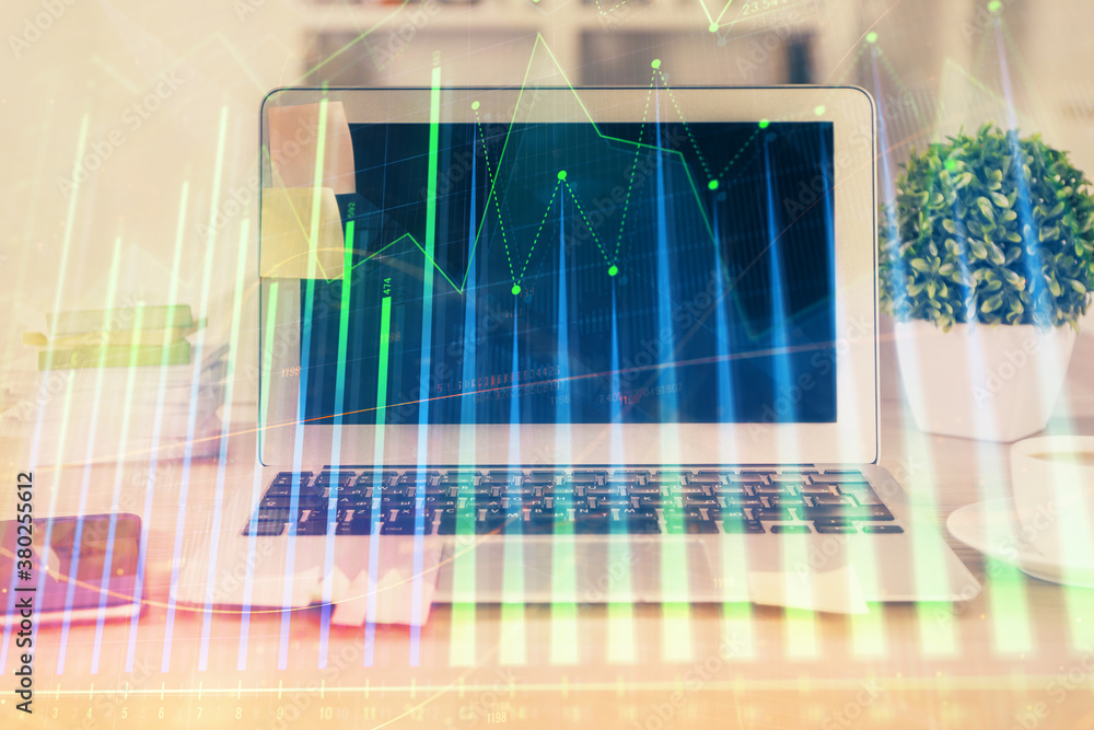 Financial market graph hologram and personal computer on background. Double exposure. Concept of forex. Financial market graph hologram and personal computer on background. Double exposure. Concept of forex.