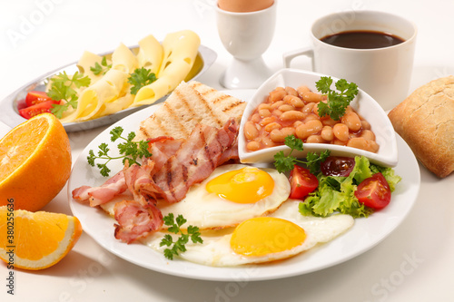 english breakfast- fried egg, bacon, toast and coffee cup