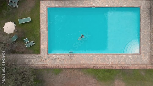 Ragazza entra in piscina, vigneti e panoramica su paesaggio Toscano