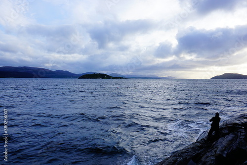 Fjord in Norway with a fisherman