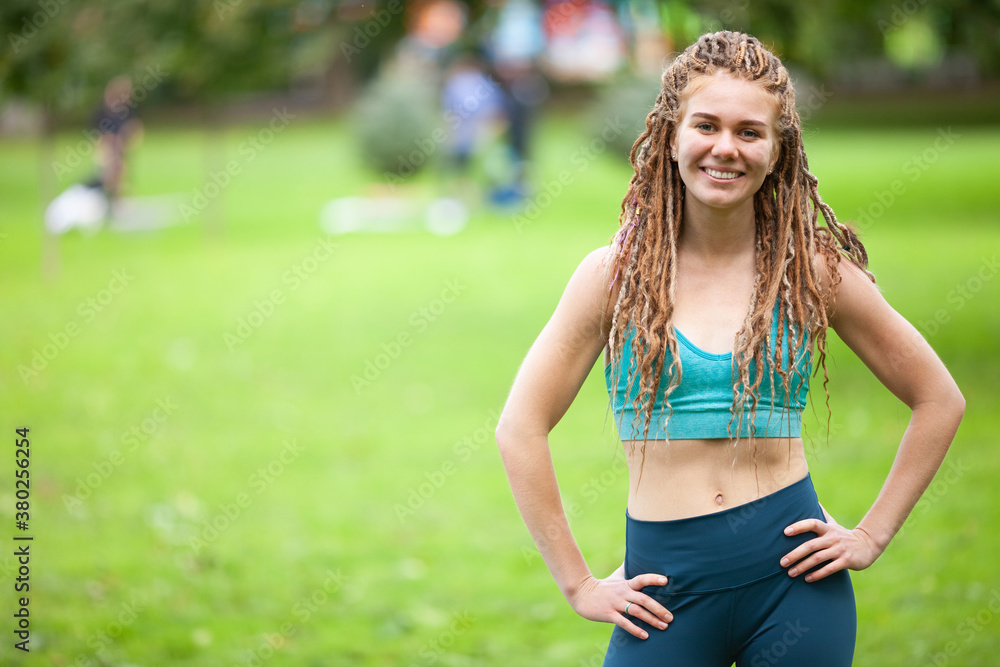 Beautiful happy girl .with dreadlocks in a park. Sports girl in a sportswear. Girl training. Copy space. Beautiful happy girl .with dreadlocks in a park. Sports girl in a sportswear. Girl training. Copy space.