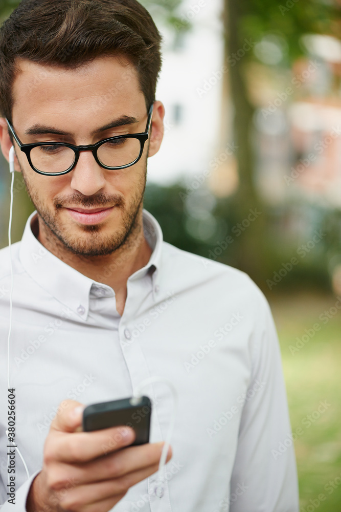 Businessman using smartphone with headphones Businessman using smartphone with headphones