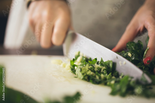 Woman Chopping Basil Leaves photo