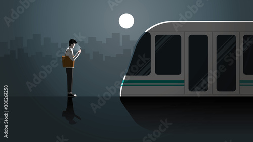 Lonely office man first jobber use smart phone waiting in public transportation station for last train at night alone in the dark and full moon light. City lifestyle of work late overtime and overwork