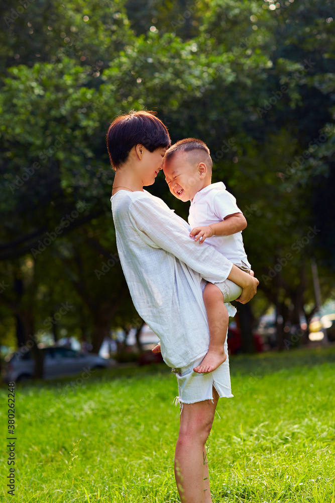 young mother with her little boy in the park young mother with her little boy in the park
