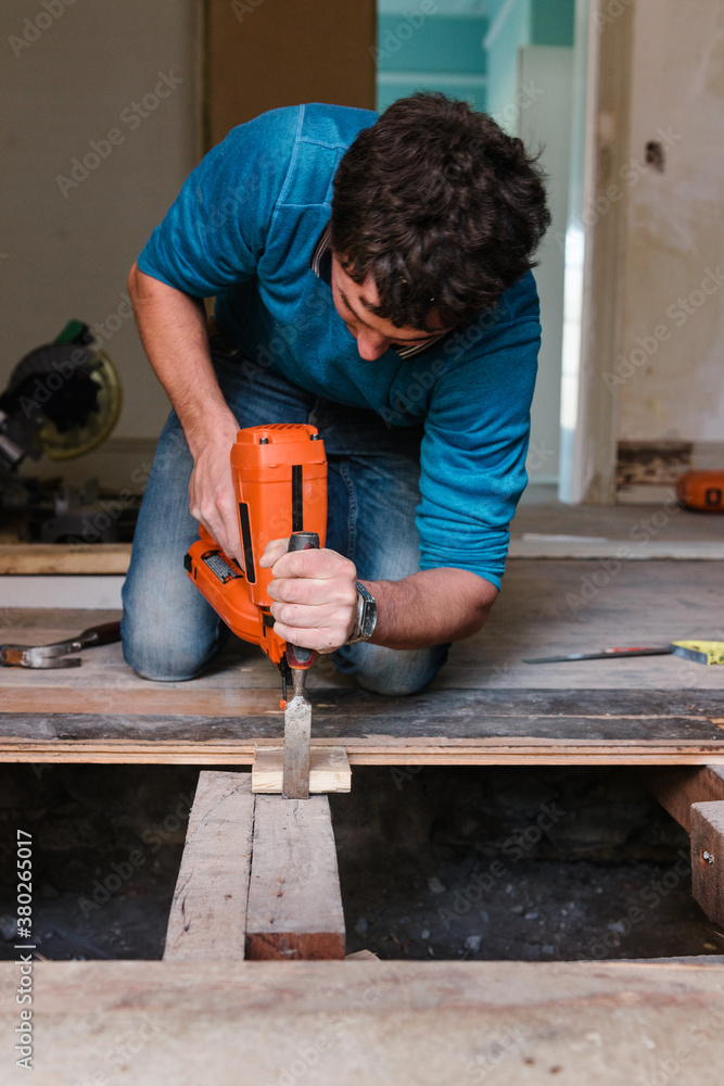 carpenter putting old floorboards back together carpenter putting old floorboards back together