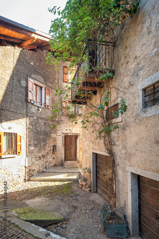 Detail of the old houses facades and alleys in Bagolino, a small town in the Lombardy Region (province of Brescia), famous for its Bagoss cheese made with goat's milk. Color image.