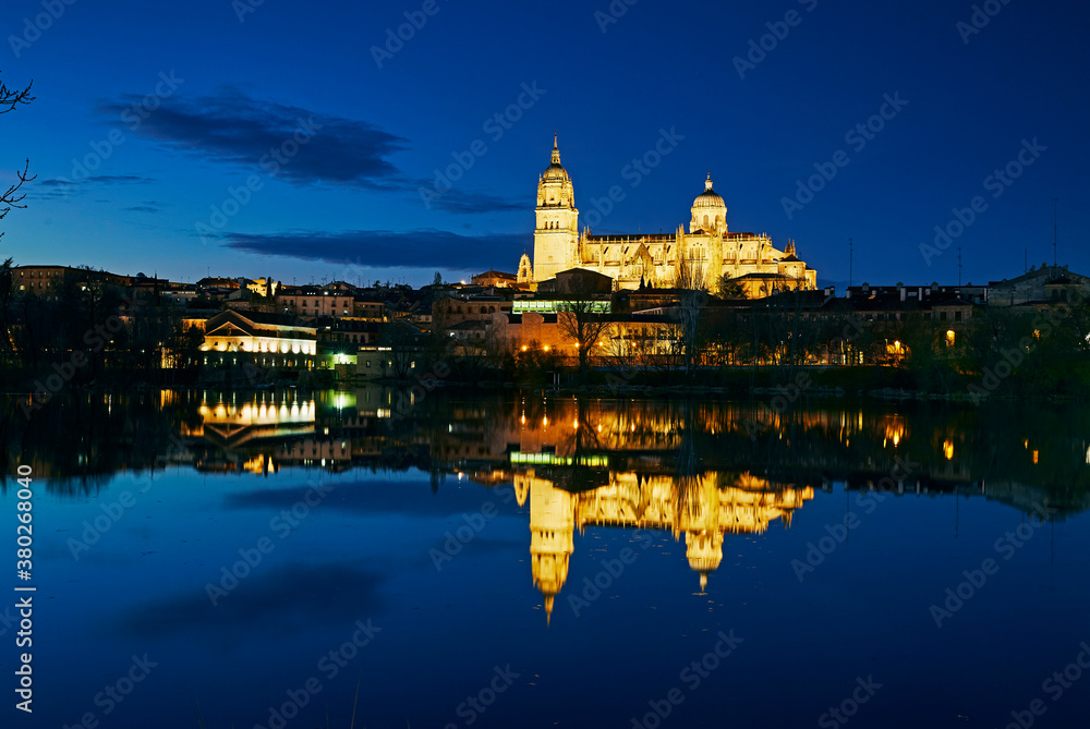 Salamanca Cathedral overlooking the River Tormes illuminated at twilight