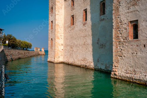External view of the Sirmione castle (former Rocca Scaligera), on the shores of Garda Lake (Lombardy, Northern Italy)  that was built in the XIII Century. © stefanopez