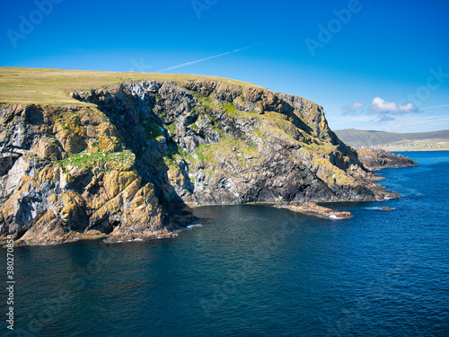 Coast cliffs at the Keen of Hamar on the island of Unst in Shetland, UK. The bedrock is Shetland Ophiolite Complex - Metaperidotite. Metamorphic Bedrock formed around 419 to 1000 million years ago. photo