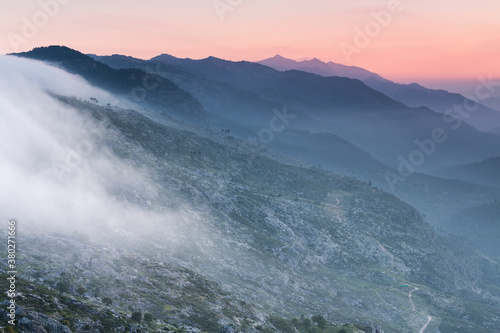 Sunrise in the mountains between clouds photo