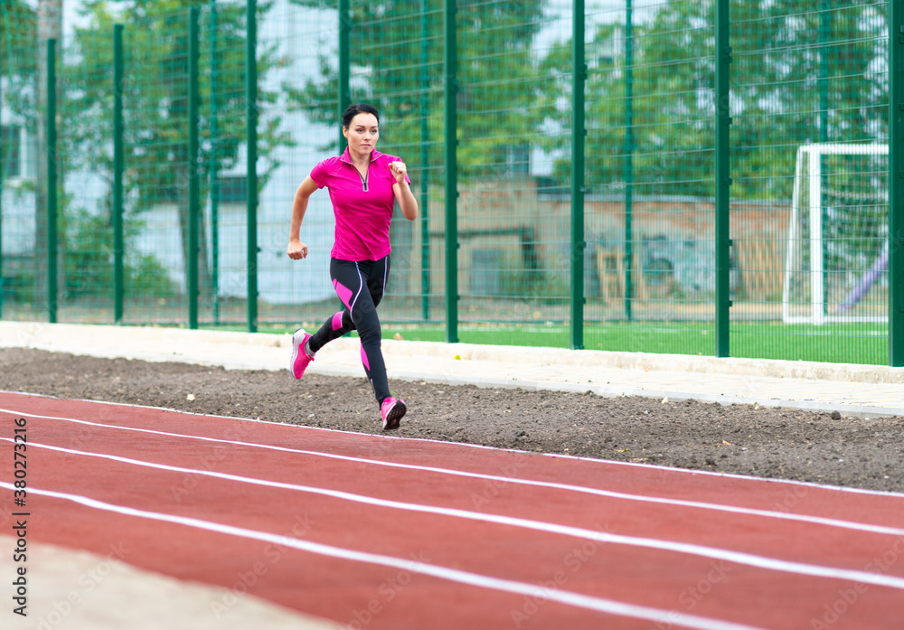 Fit healthy woman training on a race track