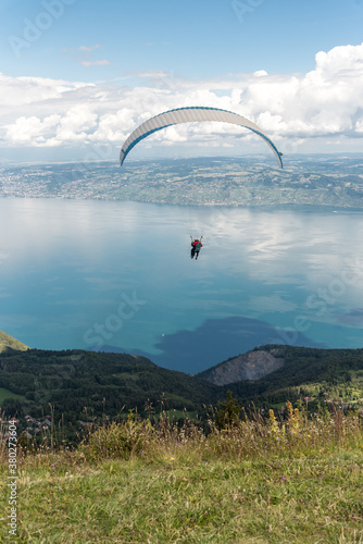 paraglider over the mountains and lake view