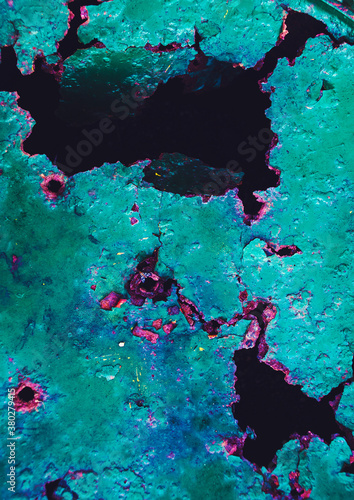 Abstract corrosive metal background with turquoise paint cracks