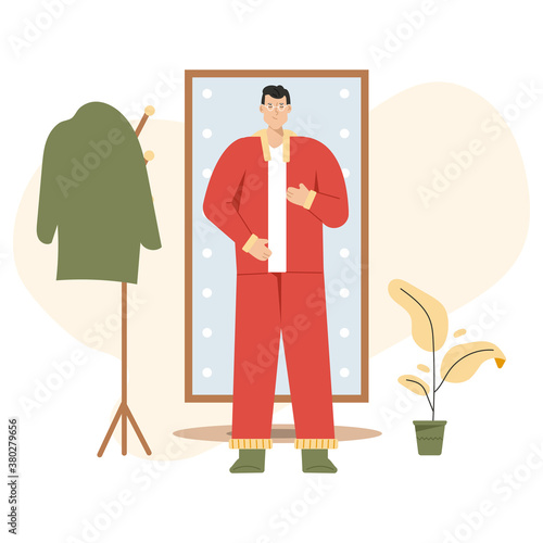 Man gets dressed in front of full length mirror