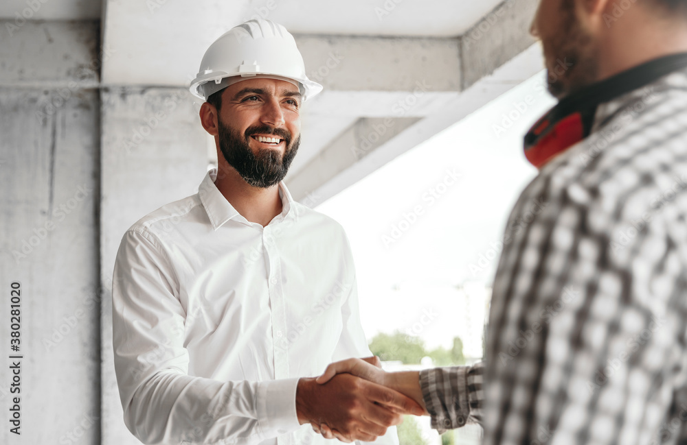 Contractor shaking hand of colleague Contractor shaking hand of colleague