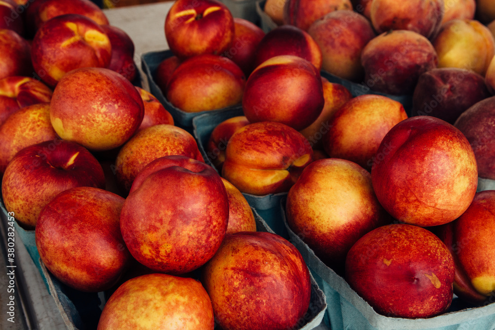 Fresh Peach in Cardboard Box on Display at a Farmer's Market Stand Fresh Peach in Cardboard Box on Display at a Farmer's Market Stand