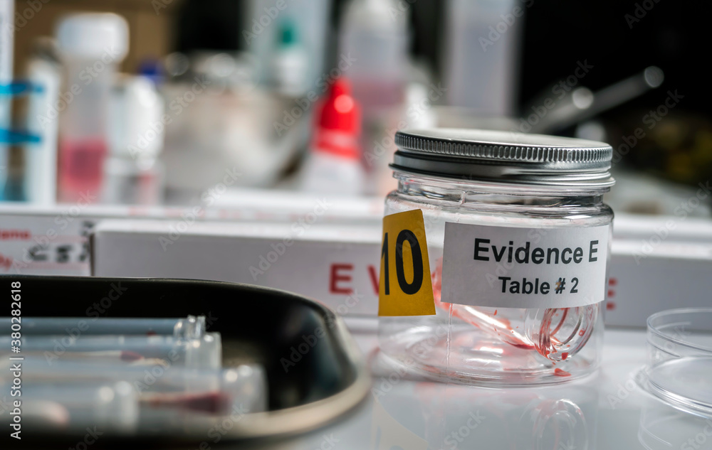 Blood-stained glass sample in an evidence jar, concept image