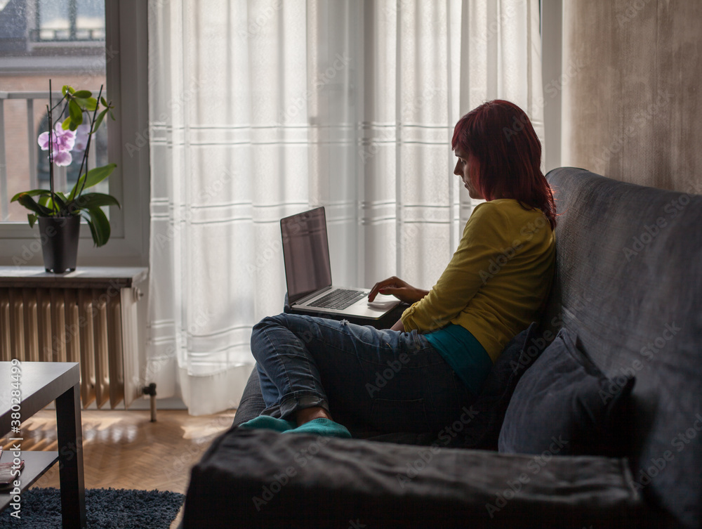 Woman Looking at Her Laptop in the Living Room Woman Looking at Her Laptop in the Living Room