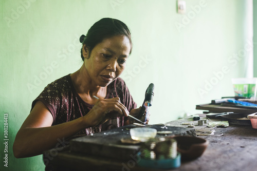 Woman making silver jewelry photo